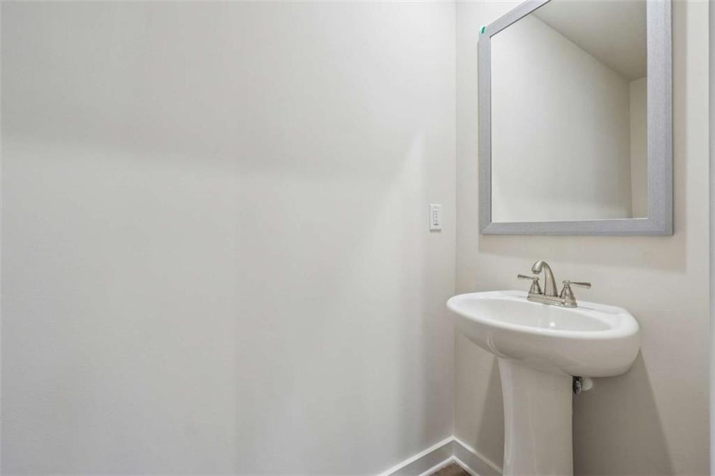 4811 Station Lane Atlanta, GA 30349 - Photo 23 of 25 a bathroom with a sink and mirror