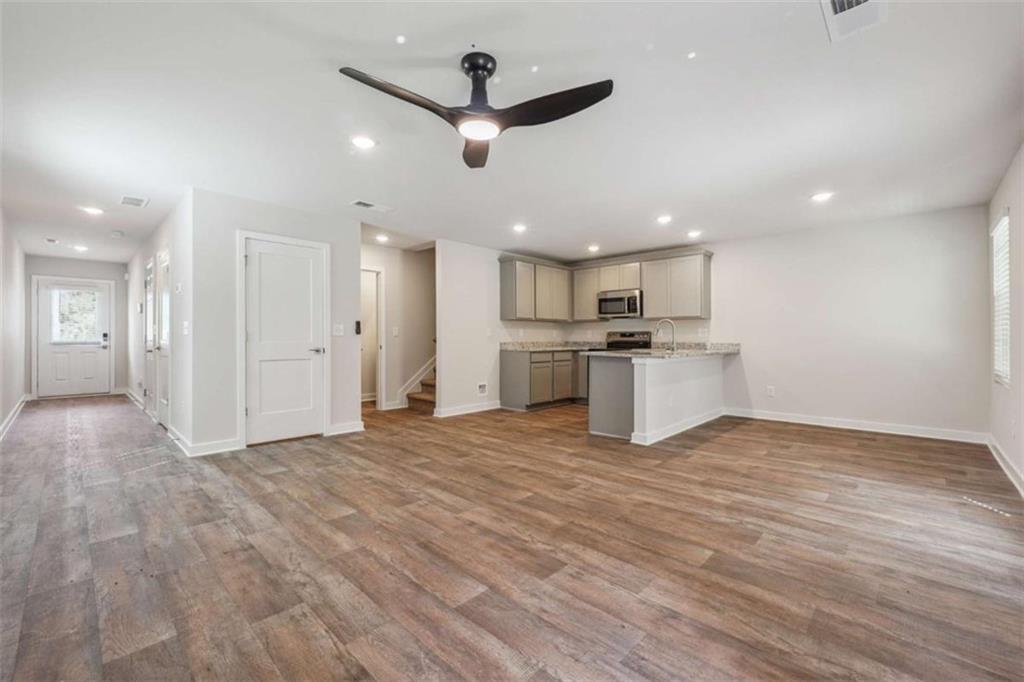 4811 Station Lane Atlanta, GA 30349 - Photo 4 of 25 a view of a kitchen with a stove cabinets and wooden floor