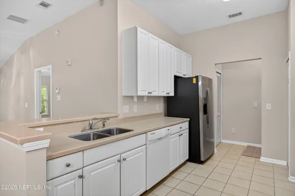 a kitchen with a sink cabinets and stainless steel appliances