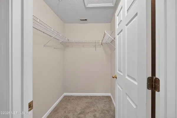 a view of staircase with white walls