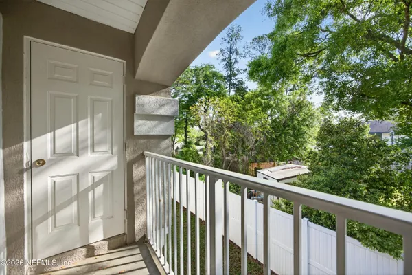 a view of a balcony with wooden floor