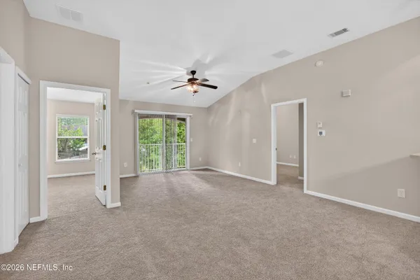 a view of empty room with ceiling fan