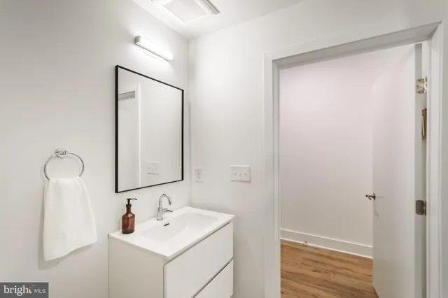 a bathroom with a sink a mirror and shower