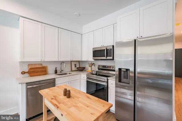 a kitchen with a refrigerator stove and microwave