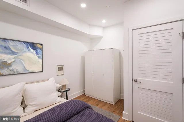 a living room with furniture and a wall painting