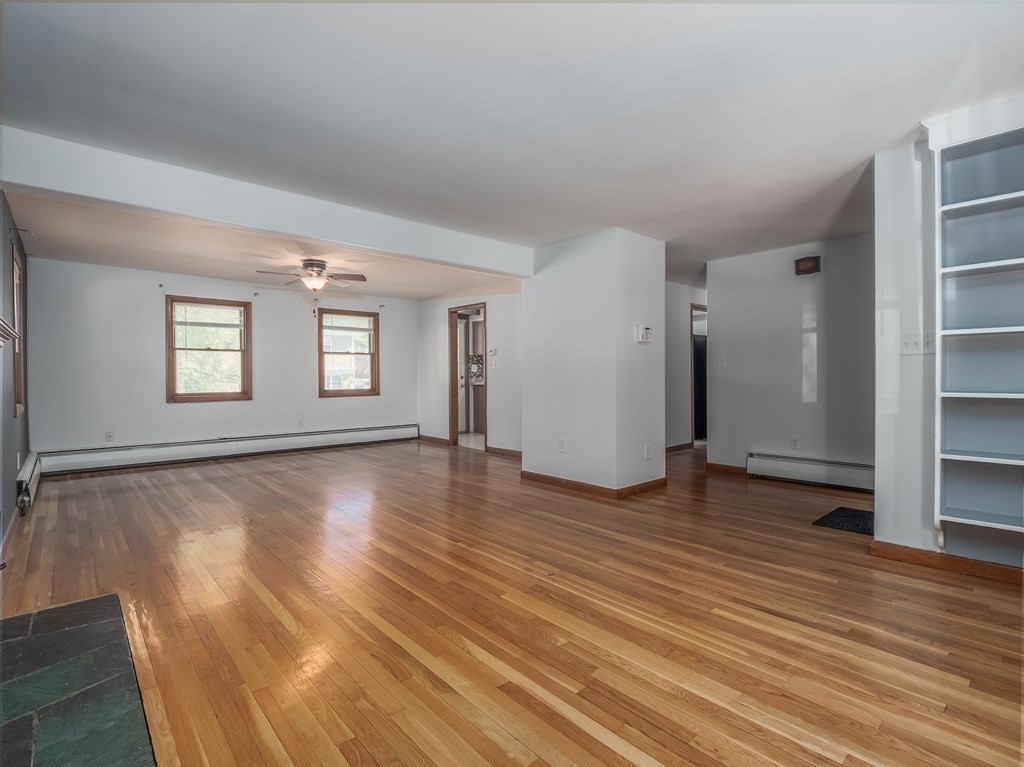 125 Columbia Road Lowell, MA 01854 - Photo 3 of 32 an empty room with wooden floor and windows