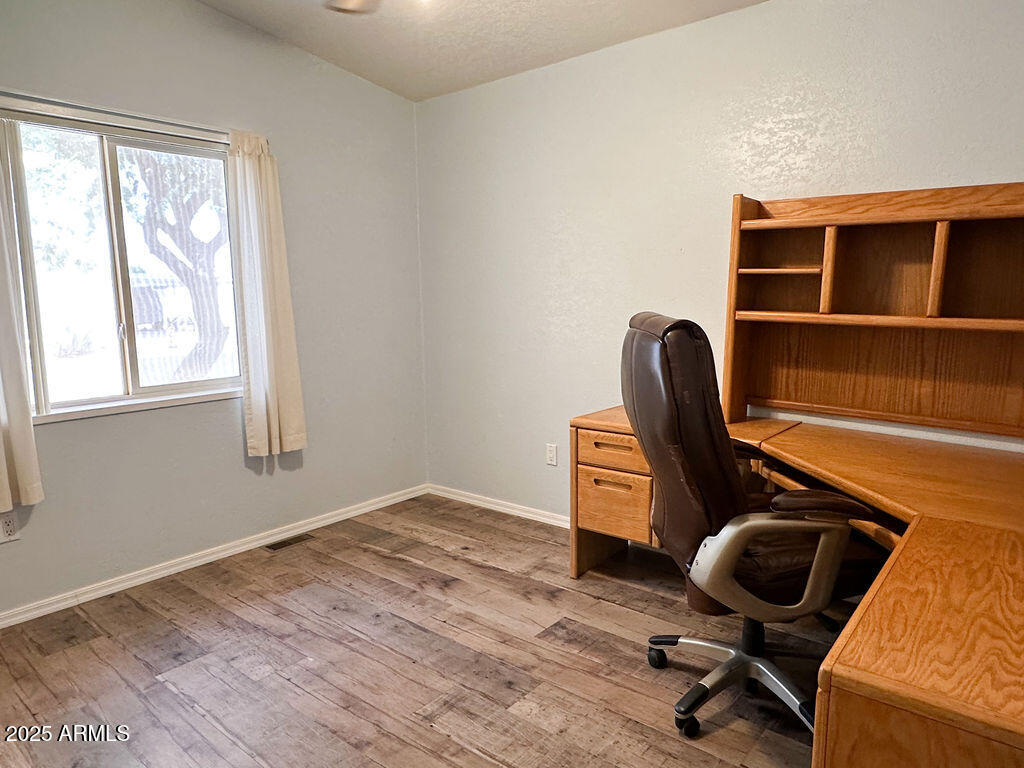 2054 North Thornton Road, Unit 140 Casa Grande, AZ 85122 - Photo 13 of 16 a view of workspace with wooden floor and windows