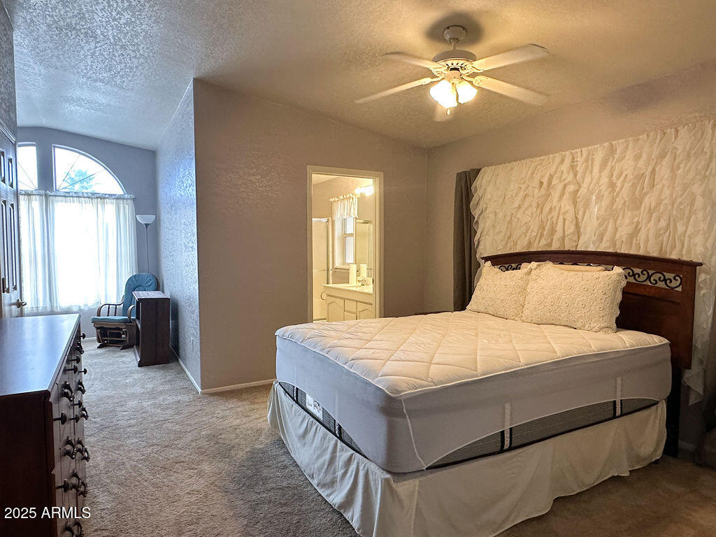 2054 North Thornton Road, Unit 140 Casa Grande, AZ 85122 - Photo 6 of 16 a bedroom with a bed and a chandelier