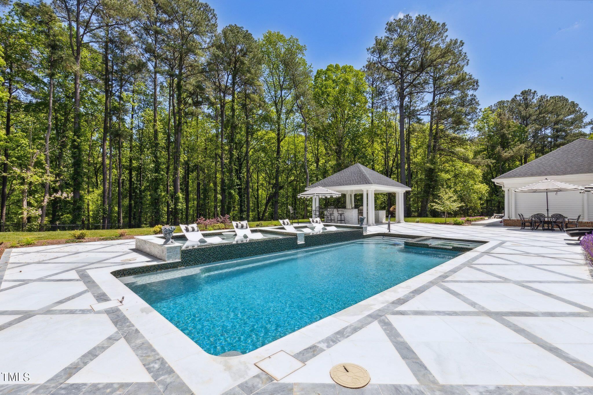 6321 Johnson Pond Road Fuquay-Varina, NC 27526 - Photo 12 of 50 a view of a swimming pool with lounge chair