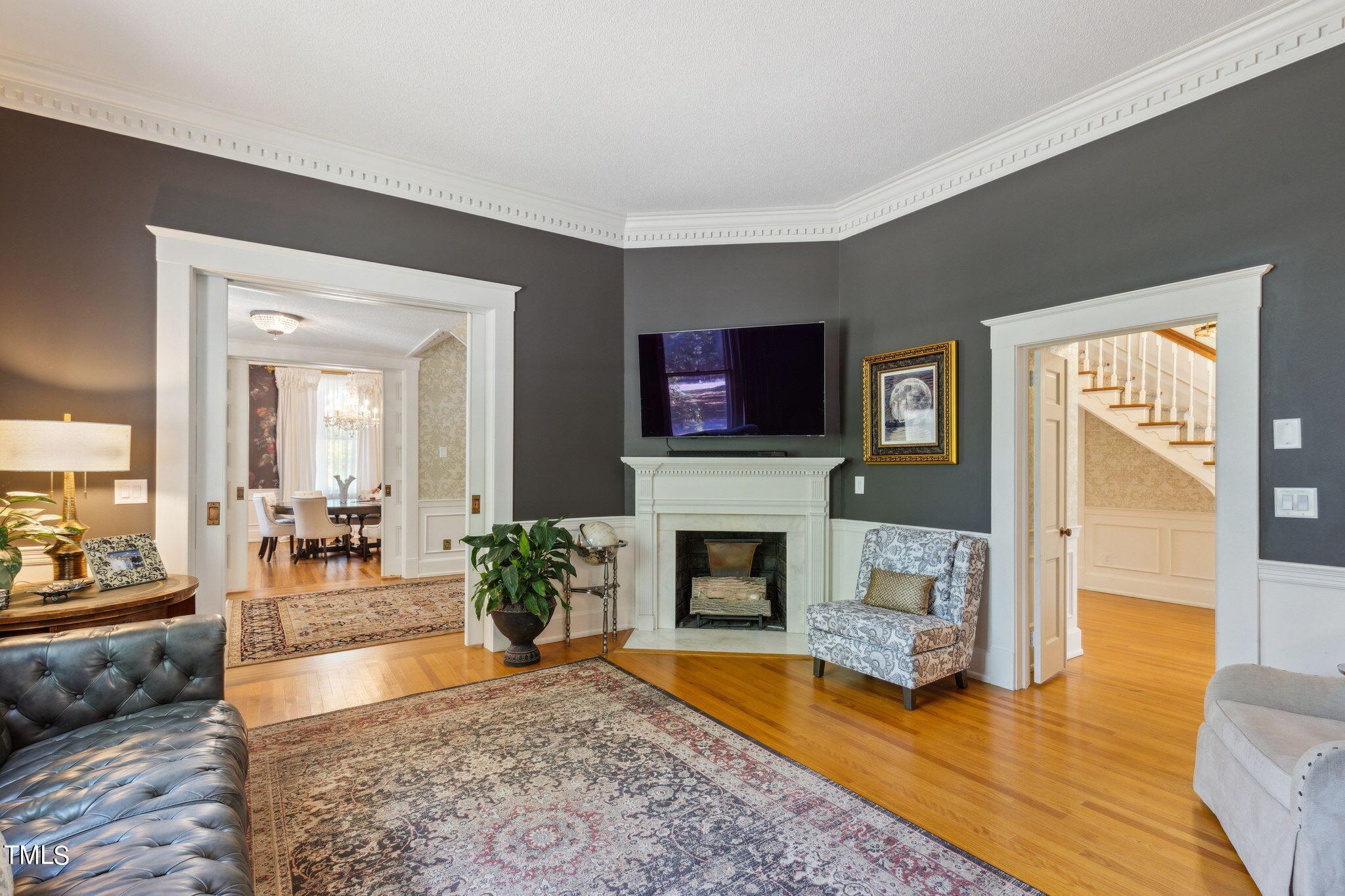 6321 Johnson Pond Road Fuquay-Varina, NC 27526 - Photo 22 of 50 a living room with furniture a flat screen tv and a fireplace