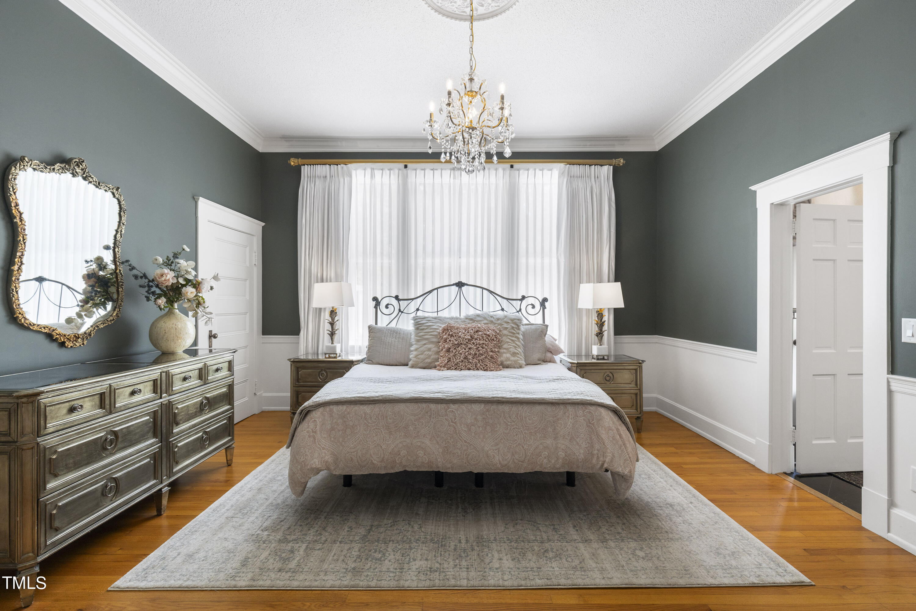 6321 Johnson Pond Road Fuquay-Varina, NC 27526 - Photo 25 of 50 a bedroom with a large bed and a chandelier