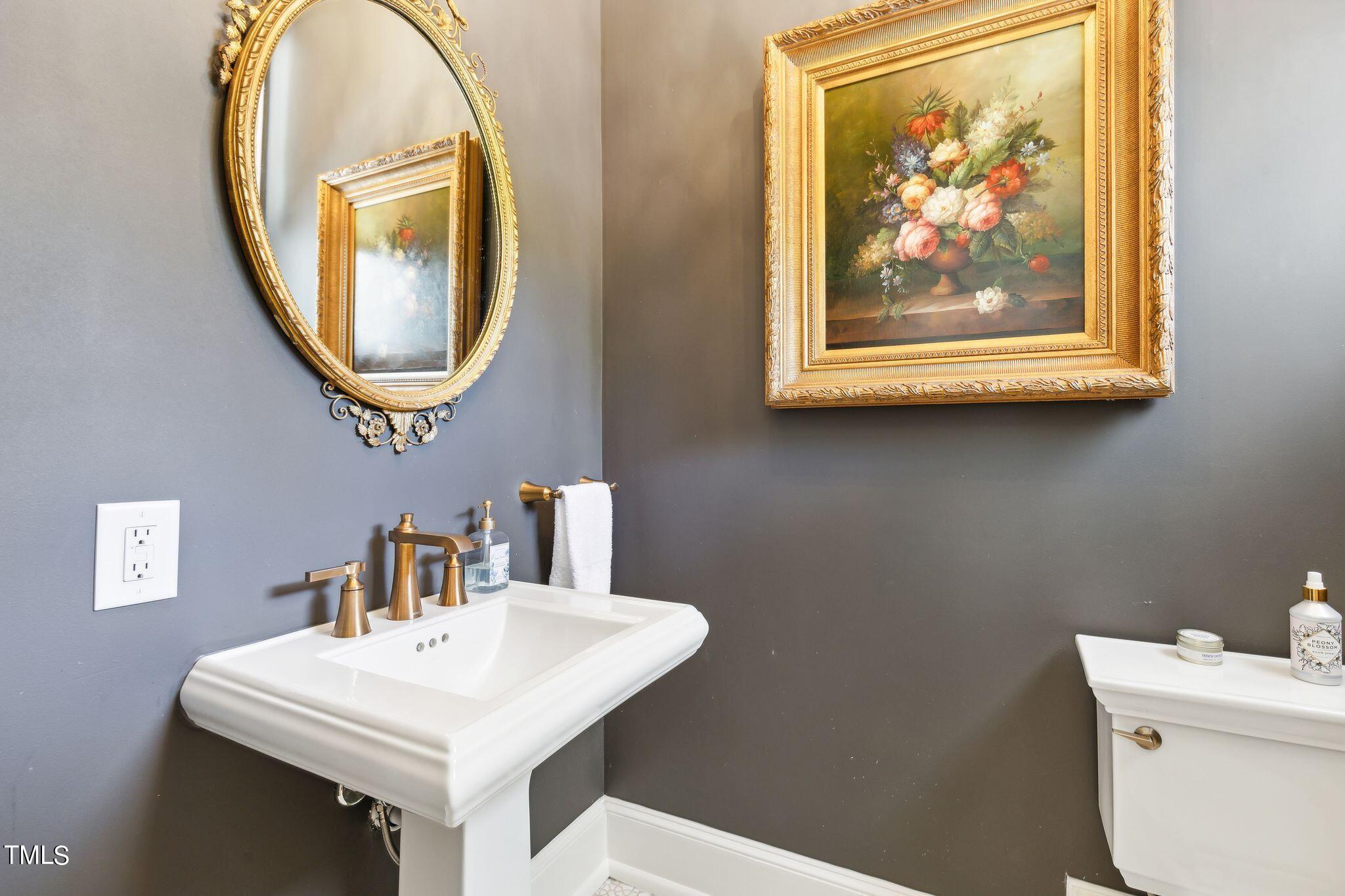 6321 Johnson Pond Road Fuquay-Varina, NC 27526 - Photo 29 of 50 a bathroom with a toilet a sink and a mirror