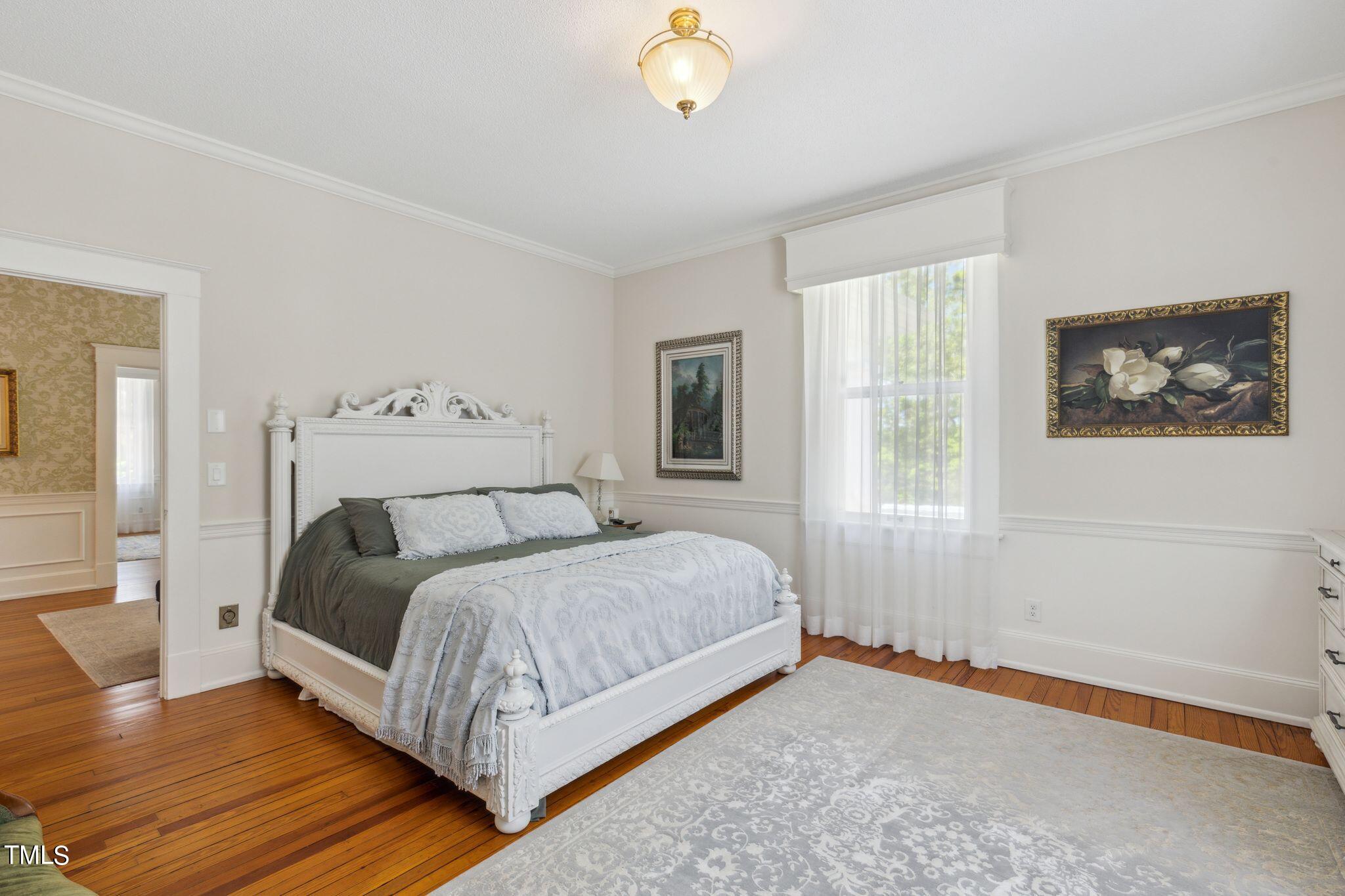 6321 Johnson Pond Road Fuquay-Varina, NC 27526 - Photo 32 of 50 a bedroom with a bed lamp and a window