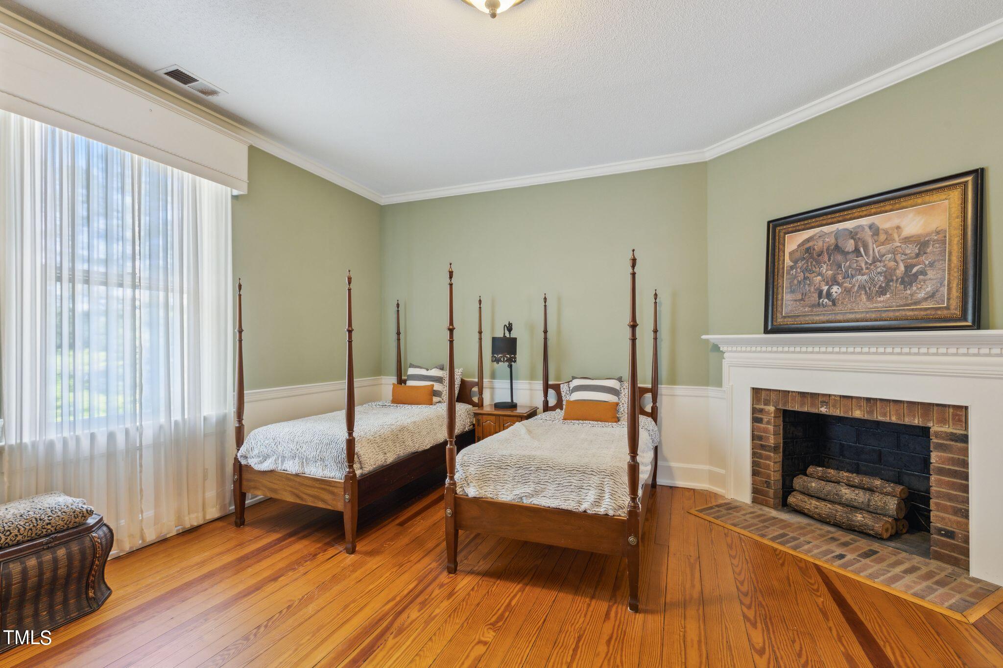 6321 Johnson Pond Road Fuquay-Varina, NC 27526 - Photo 34 of 50 a bedroom with furniture and a fireplace