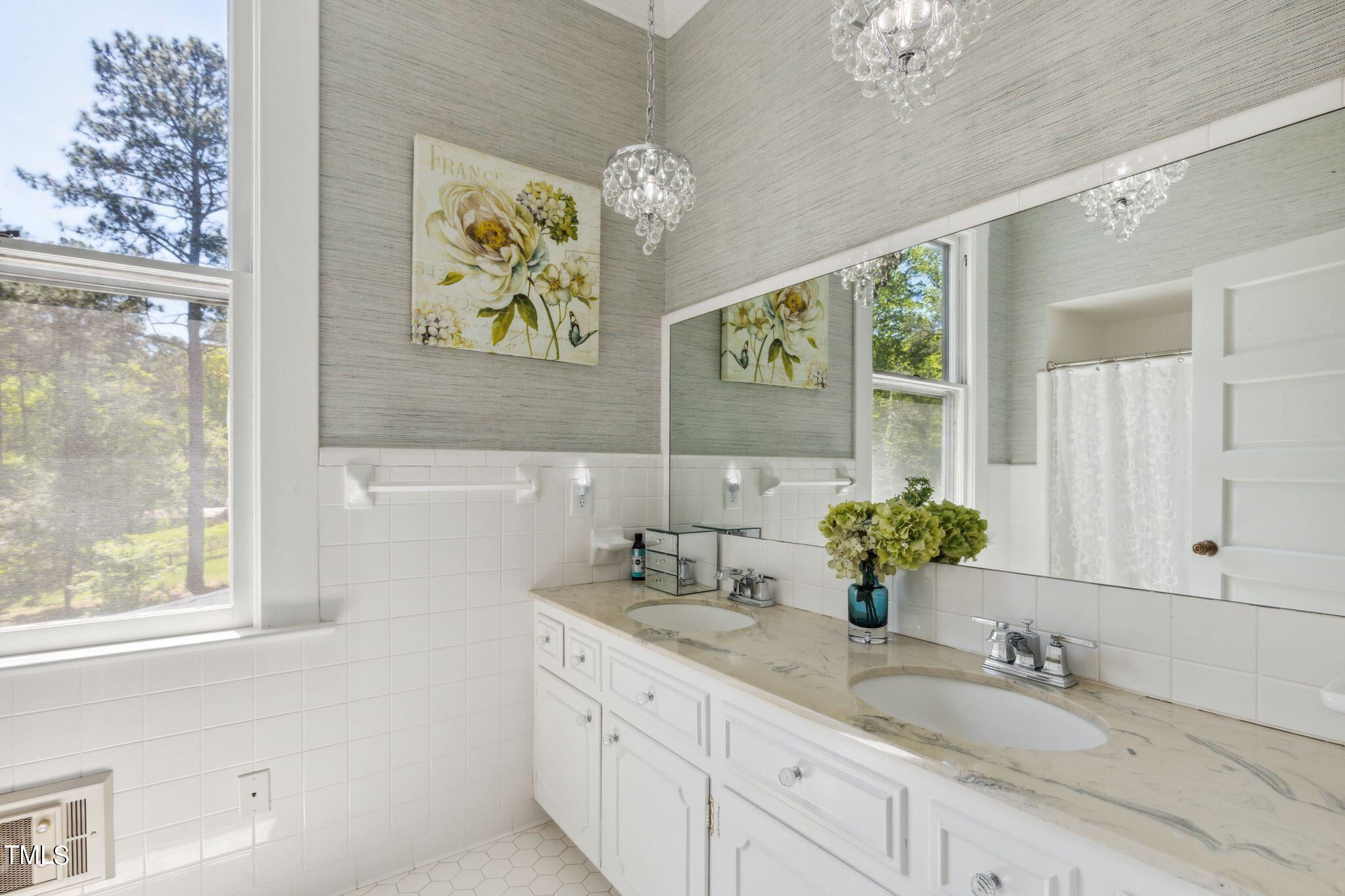 6321 Johnson Pond Road Fuquay-Varina, NC 27526 - Photo 35 of 50 a bathroom with a double vanity sink and a mirror
