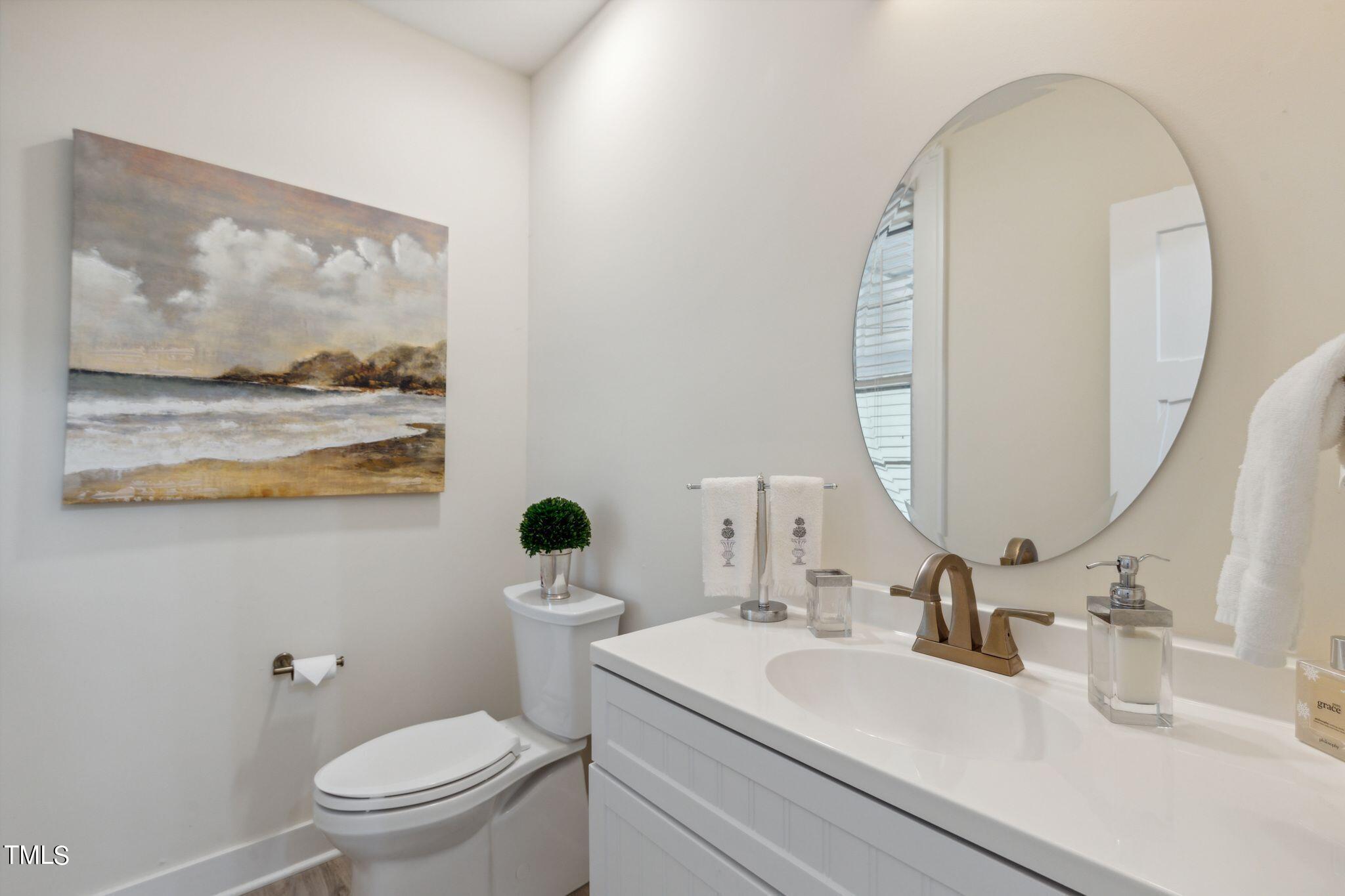6321 Johnson Pond Road Fuquay-Varina, NC 27526 - Photo 48 of 50 a bathroom with a toilet a sink and mirror