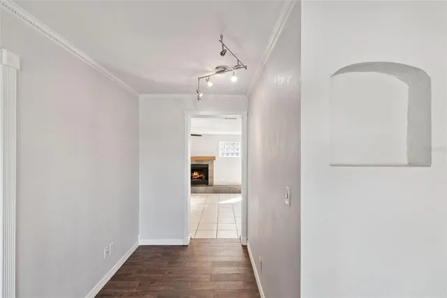 a view of a hallway with wooden floor