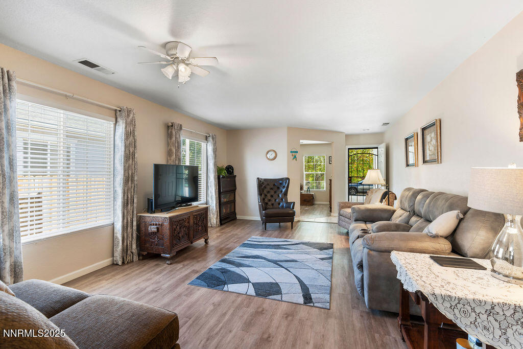7685 Bichon Street Reno, NV 89506 - Photo 11 of 29 a living room with furniture and a flat screen tv