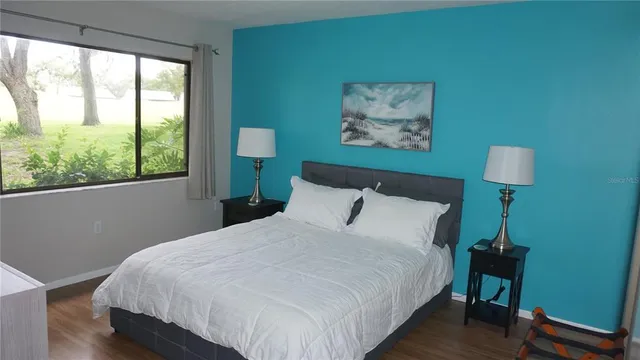 a bedroom with a bed and a window