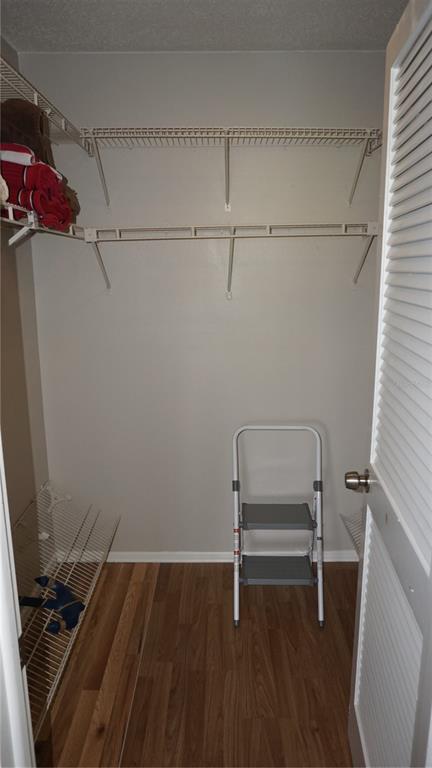 13012 Wedgewood Way, Unit A Hudson, FL 34667 - Photo 19 of 29 a room with a chair and wooden floor