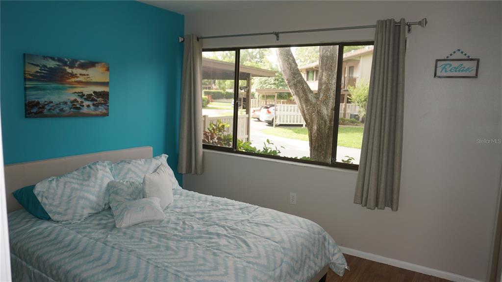 13012 Wedgewood Way, Unit A Hudson, FL 34667 - Photo 20 of 29 a bed sitting in a bedroom next to a window