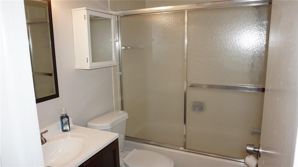 13012 Wedgewood Way, Unit A Hudson, FL 34667 - Photo 21 of 29 a bathroom with a sink toilet and shower