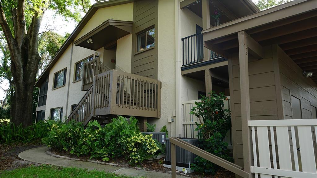 13012 Wedgewood Way, Unit A Hudson, FL 34667 - Photo 3 of 29 a front view of a house with plants and trees