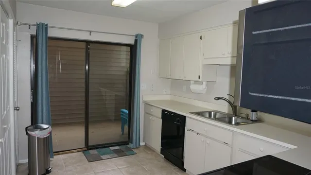 a kitchen with a sink and a mirror