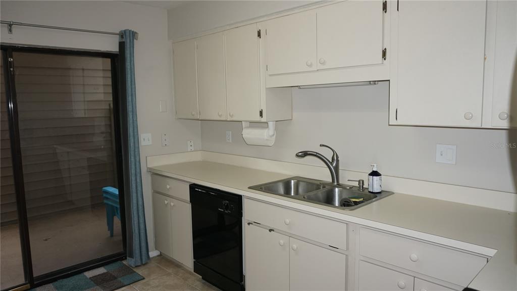 13012 Wedgewood Way, Unit A Hudson, FL 34667 - Photo 7 of 29 a kitchen with a sink and cabinets