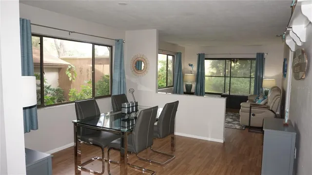 a view of a dining room with furniture window and wooden floor