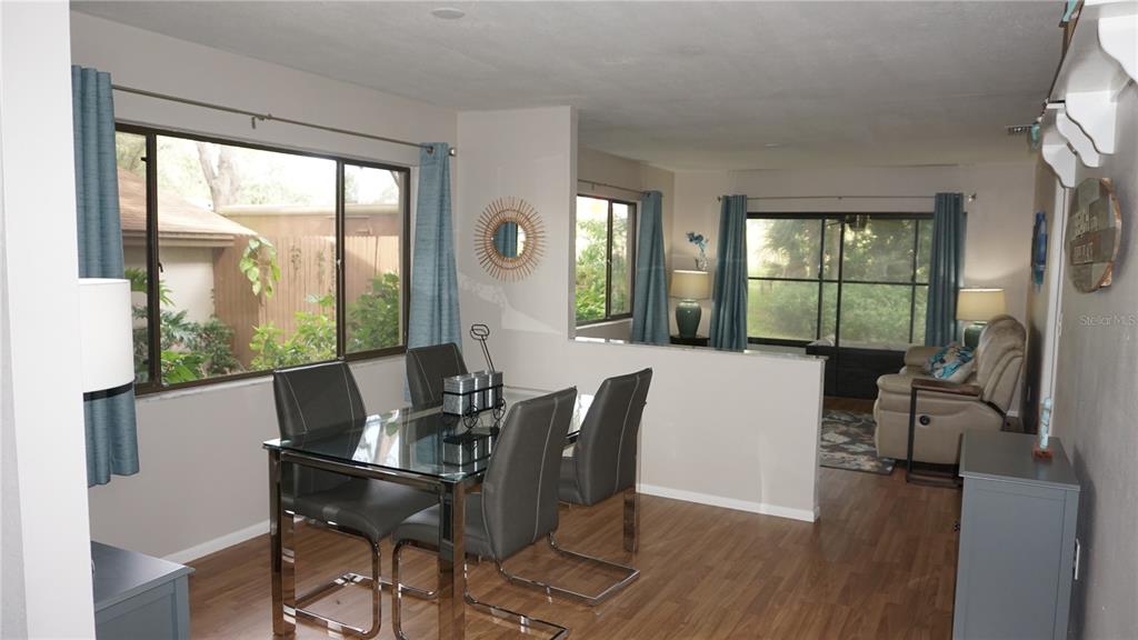 13012 Wedgewood Way, Unit A Hudson, FL 34667 - Photo 9 of 29 a view of a dining room with furniture window and wooden floor