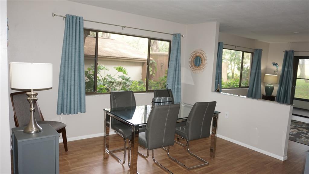 13012 Wedgewood Way, Unit A Hudson, FL 34667 - Photo 10 of 29 a view of a dining room with furniture window and wooden floor