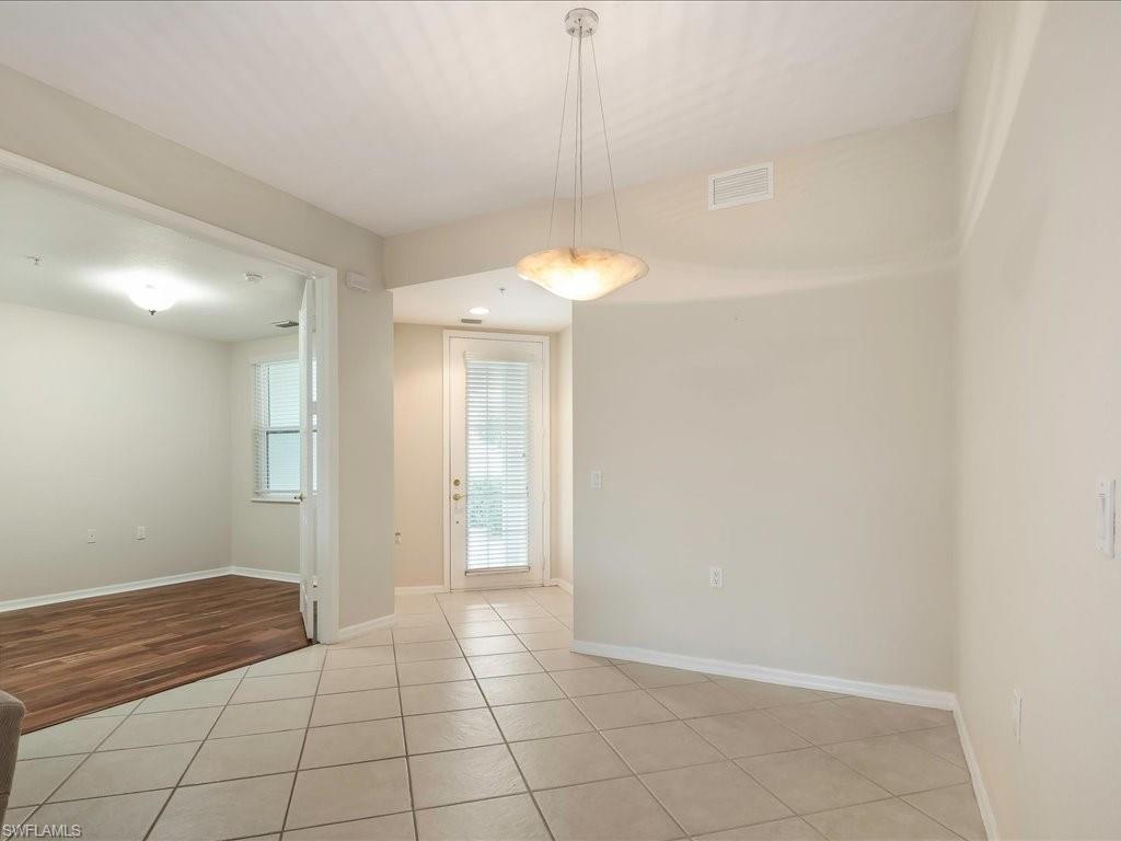 4655 Hawks Nest Way, Unit 103 Naples, FL 34114 - Photo 13 of 33 a view of an empty room and window in a room