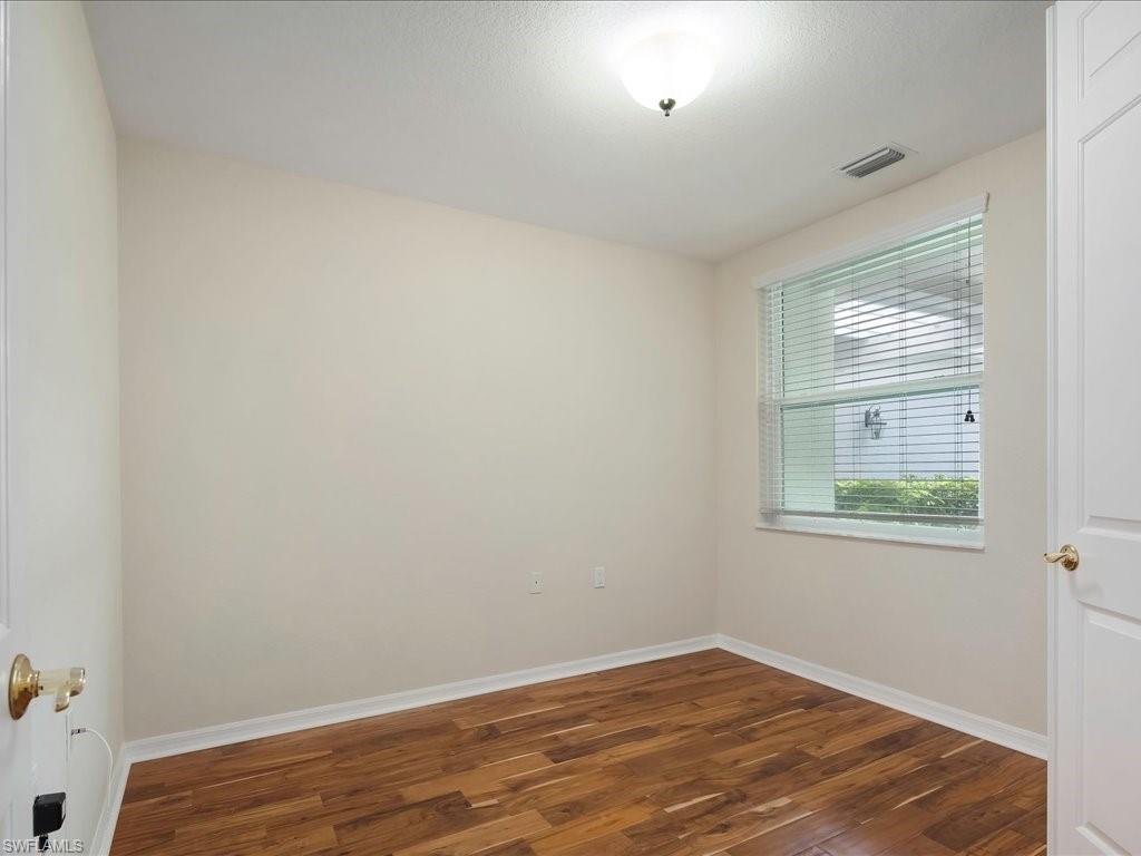 4655 Hawks Nest Way, Unit 103 Naples, FL 34114 - Photo 14 of 33 an empty room with a window