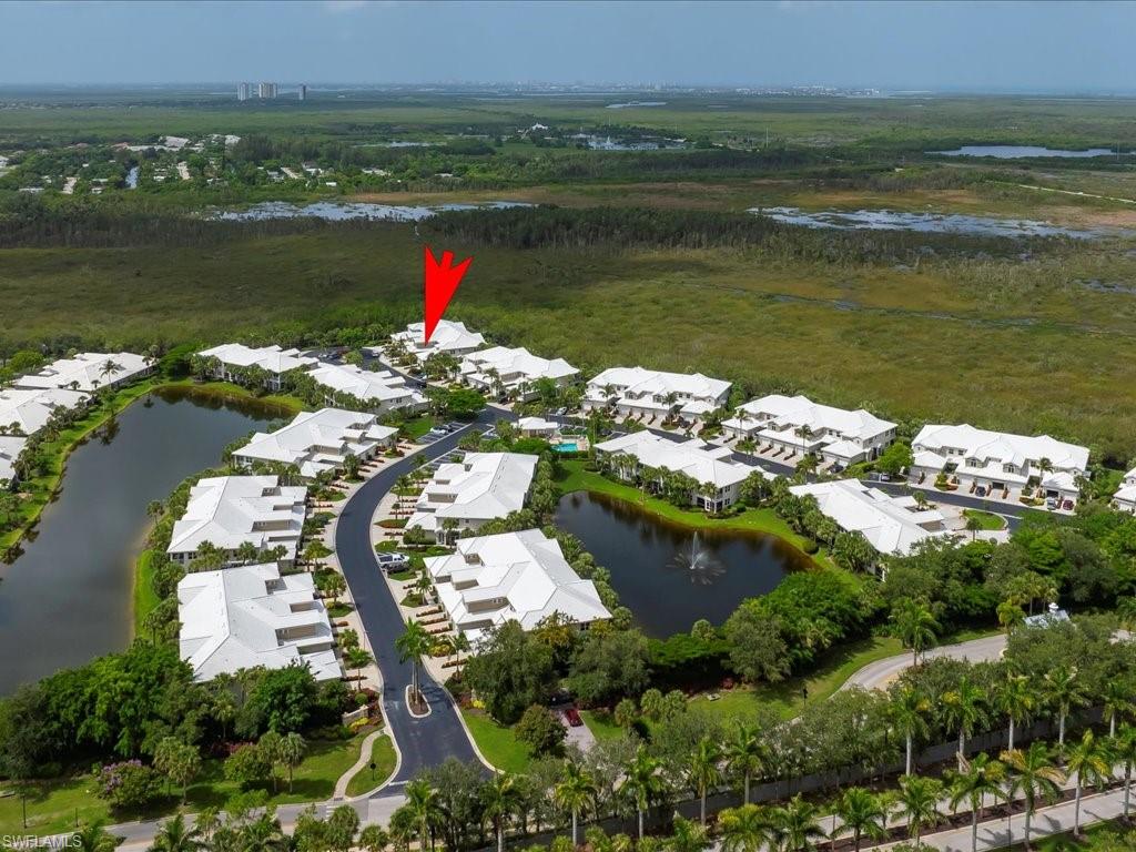 4655 Hawks Nest Way, Unit 103 Naples, FL 34114 - Photo 27 of 33 an aerial view of lake residential house and outdoor space