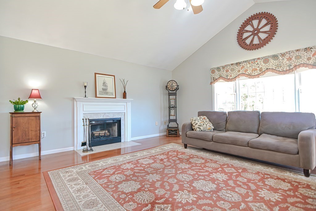 47 Hidden Road Dracut, MA 01826 - Photo 11 of 28 a living room with furniture and a fireplace