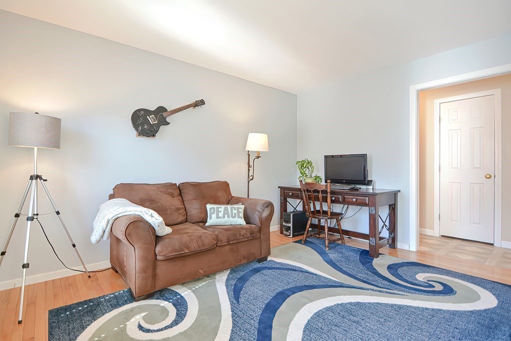 47 Hidden Road Dracut, MA 01826 - Photo 16 of 28 a living room with furniture and a flat screen tv