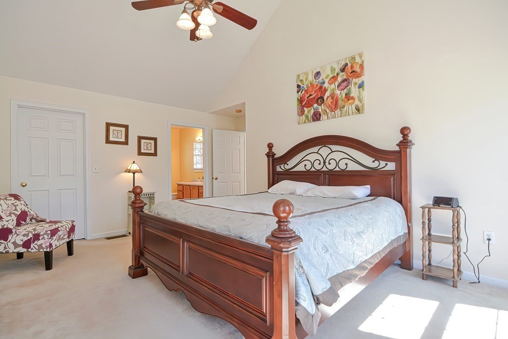 47 Hidden Road Dracut, MA 01826 - Photo 17 of 28 a bedroom with a bed and a chandelier