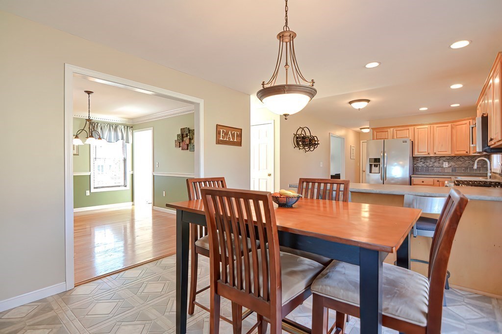 47 Hidden Road Dracut, MA 01826 - Photo 7 of 28 a view of a dining room and livingroom with furniture wooden floor a chandelier