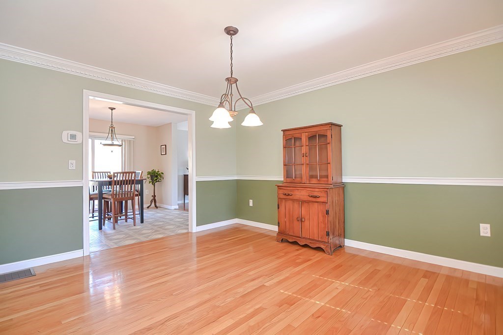 47 Hidden Road Dracut, MA 01826 - Photo 10 of 28 a room with lots of wooden furniture and mirrors