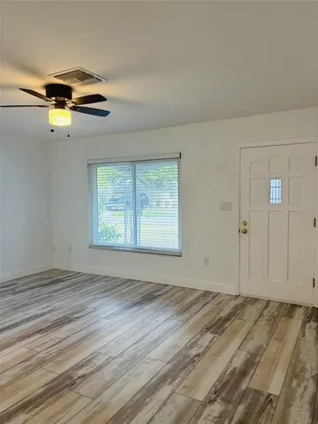 a view of empty room with ceiling fan