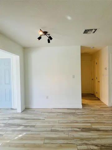 a view of a room with wooden floor