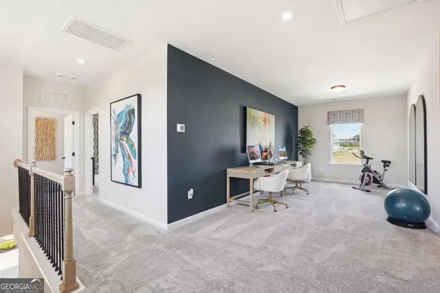 a view of a livingroom with furniture and a flat screen tv