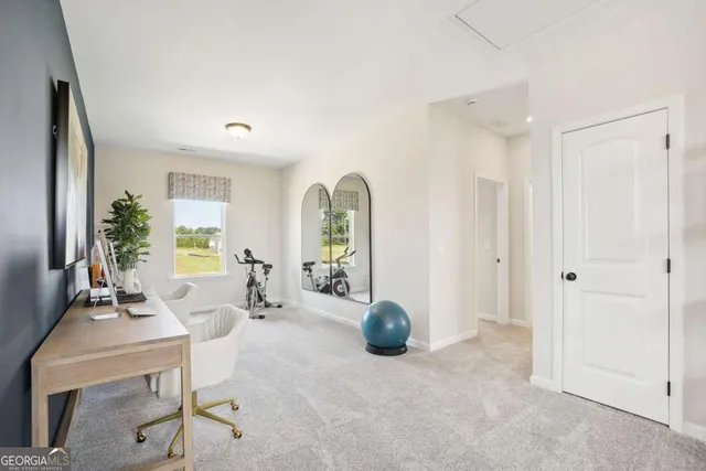 a view of a livingroom with furniture and a potted plant