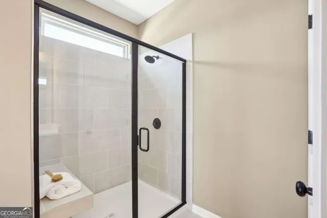 a bathroom with a glass shower door