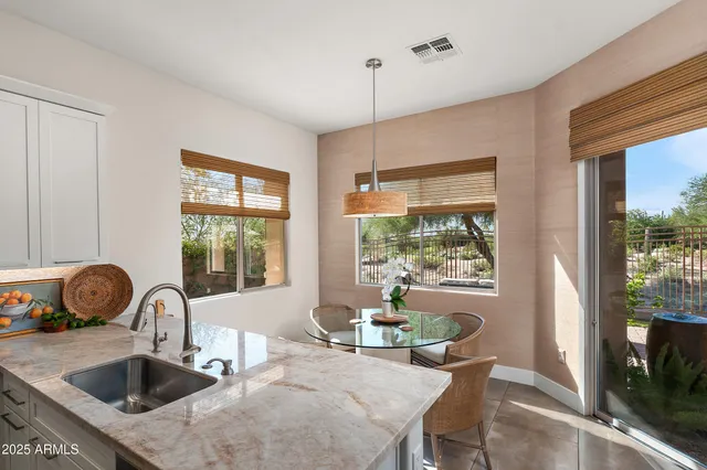 a kitchen with a table chairs and a sink
