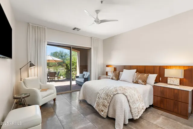 a bedroom with a bed couch and window