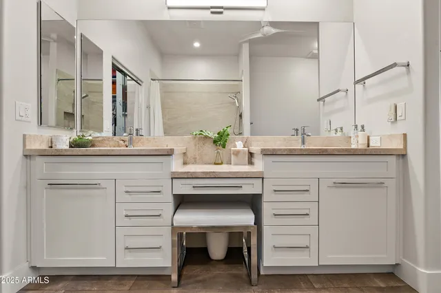 a white sink vanity with mirror