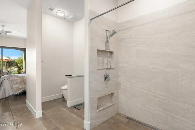a bathroom with a granite countertop shower and a toilet