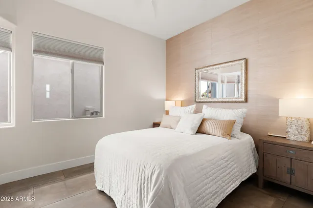 a bedroom with a bed and a night stand